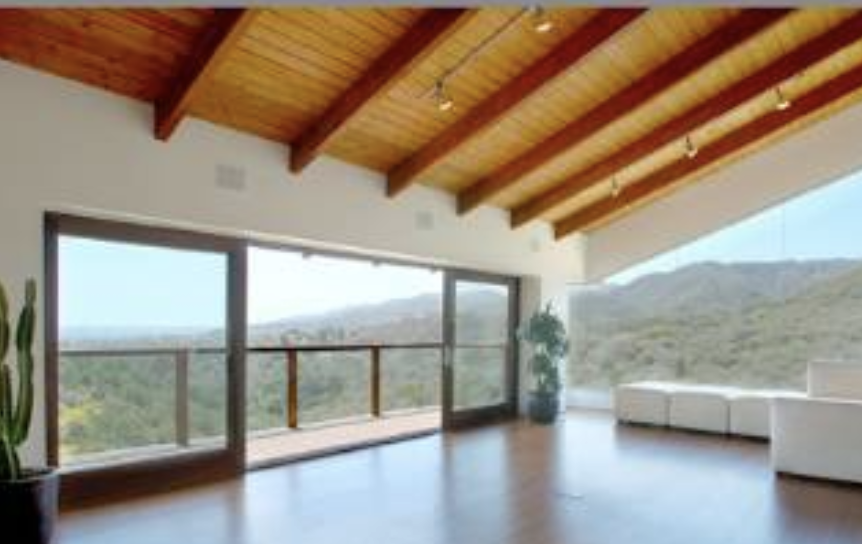 High above upper Temescal Canyon & State park lands, nature is a permanent guest in this reconceived modernist home of wood, concrete and glass. Soaring & open plan public spaces provide an expansive living room, dining area & elegantly detailed kitchen w/professional appliances; all sited to capture sweeping views of mountain greenery & the Pacific Ocean. With 3 bds plus an office/guest room & 3 full baths, one feels far from urban pressures in a private retreat. Grassy yard & sloping gardens.
