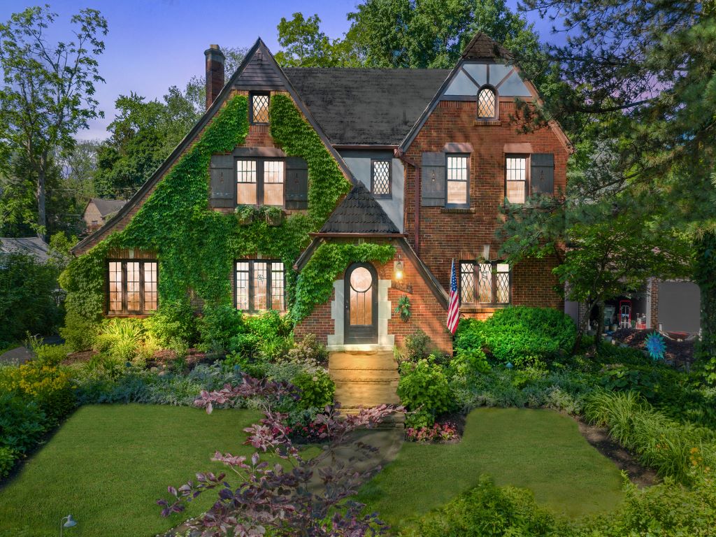 Rarely available 100-year-old Tudor in the “Front of The Woods”. Hand-cut cedar shake roof,
original 52 leaded glass windows, bluestone front walk, English country-style gardens
complementing the Pewabic tiled pool. Inside ornate moldings, original wood floors
throughout. Vestibule, entry hall, living room with a large mantel, two leaded glass archway
doors, and French doors that open onto a four-season garden room overlooking the pool. A
windowed family room has built-in leaded glass bookcases. Formal dining room. The kitchen
has handmade tiles, soapstone sink & countertops, an artistically designed bar, and a
cozy breakfast nook. Unique half bath. Wrought iron stairway to the second floor that features
an office, four bedrooms, half and full bath, linen closet, original light fixtures in rooms and
hallway. Additional fifth bedroom with full bath and cedar closet on the third floor with great
unfinished attic space. Full basement. Two brick outbuildings shed and pool house.