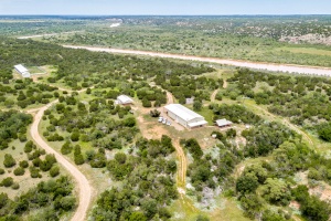 One Of A Kind! - Nestled amongst the banks of the historic Pease River (located on paved FM 104), Rustic River Ranch consists of approximately 353 acres of some of the most diverse terrain one can imagine for this part of the Texas Panhandle.  High bluffs along the river provide excellent glassing opportunities, while deep canyons and arroyos provide plenty of shade and cool areas for the wildlife.  The large hardwood trees offer great roosting spots for the numerous turkeys.  The half-mile of gravel and reclaimed asphalt driveway, and thick brush cover of mesquite and juniper, provide excellent privacy. With the numerous varieties of wildlife on the property, Rustic River Ranch also pulls wildlife from the huge neighboring ranches that have little to no hunting pressure. The 3 cultivated fields (66 acres, 18 acres and 17 acres) are in wheat and sorghum. 8 food plots offer milo, wheat, and peanuts for excellent nutritional value to the wildlife.  Wildlife seen across the ranch include mule deer, white tail deer, turkey, hogs, rabbits, dove, sandhill cranes and a healthy quail population. Which in turn draws coyotes, bobcats, raccoons and the very elusive badger.  With the Pease River meandering through the northern portion of the ranch for approximately 1/2-mile, 3 water wells with pressure tanks in insulated well houses, approximately 3 miles of underground water lines, and irrigation to all 8 of the food plots, the wildlife have numerous options for drinking water.  Built in 2012, the 4-bedroom, 3-bathroom barndominium is approximately 1800 sq. ft., with central heat and air, featuring aspen and hand-hewn cypress staircase, old barn tin ceiling and wainscoting accent, and stained concrete floors. The gathering room features a heavy duty, double door, Fisher wood burning stove that can heat the entire barndominium. The kitchen features granite counters, abundant storage, stainless steel appliances including a 5-burner gas range, built in microwave, dishwasher and side-by-side refrigerator/freezer. Downstairs are 2 oversized bedrooms and 2 bathrooms. The baths feature granite counters and tile showers. Upstairs are 2 additional bedrooms and another full bath with granite counter and tile floor. Laundry facilities include top of the line, extra-large front-loading washer and dryer. Between the 480 sq. ft east facing covered porch and the 520 sq. ft covered outdoor kitchen (with custom wood fired pizza oven from Italy, extra-large Green Egg Smoker, extra-large deep fry burner, built-in Jenn-Aire gas grill, stainless steel refrigerator, stainless steel sink, granite counters, and cabinets with stainless steel doors), you will certainly not struggle trying to find room for entertaining. 3 separate enclosed stations feature Promatic Hardwired Sporting Clay machines for a fun afternoon of target practice. The shop is 50x40 with 2 overhead doors measuring 14x14 with electric opener, and 12x12, concrete floors, electricity, 4 skylights and a 20x40 covered parking area.  The 24x24 insulated cleaning house has a 24x22 covered parking area and inside features metal surround for extra cleanliness. Also, inside is a 12x10 walk-in cooler, electric hoist, stainless steel counter, stainless steel sink, stainless steel table, water heater, chest freezer, a sloped concrete floor with drain, heat and a/c. The flight pen/aviary is 72x144, built with 2 7/8 steel pipe with exterior concrete footing surround to prevent critters from digging in. This area also has a 20x144 metal roof and a 52x144 netting roof along with running water. Adjacent to the flight pen is a 20x20 metal storage building with concrete floor and electricity. High Speed Fiber Optic internet (with Wi-Fi) is available and supplied by Santa Rosa Communications. Property comes with 9 HB 700# EZ Reach wildlife feeders along with 9 rifle blinds and 3 bow blinds. Only 18 miles Southeast of Childress, this ranch offers excellent access anytime of the year. Childress has a public airport with a paved runway almost 6000 ft long. With accessibility like this, the Rustic River Ranch is not only perfect for permanent country living or family getaways, it is ideal for large hunting parties or corporate retreats.
VIRTUAL TOUR: Click on Virtual Tour to see aerial video.
MAPS: See Attachments for maps.
MINERALS: Subject to previous reservations of record.  No minerals convey. No current production on the property.		
WIND RIGHTS & WATER RIGHTS: All Wind rights and Water rights will convey. 
FSA BASE ACREAGE:  USDA/FSA Government Program includes 49.2 acres of Wheat Base with 20 lb. PLC Yield.  All Base acres to convey.  See attachments for FSA Map and FSA 156.
FENCES: Some fair to good barbed wire fence on north and northwest boundary. No other fences. 
WATER:  Three domestic wells, with locations, approximate depth and approximate gallons per minute as follows:  #1 at entry, 60 and 30 gpm; #2 at cleaning station 70 and 25 gpm; #3 at south end 180 and 60 gpm (tested at 100 gpm with a larger pump)
GROUNDWATER DISTRICT: The property lies within the Gateway Groundwater Conservation District.
TAXING DISTRICT: Although the property lies in Cottle County, it is in Childress Independent School District.  Taxes for 2018 were approximately $2,400.
UTILITIES:  Electric.  High Speed Internet and Satellite TV is accessible.
SEPTIC SYSTEM: In place.
ZONING: Agricultural. Located outside of any municipality.
EASEMENTS:  Electric line.  There are no known easements that will interfere with the operation of the ranch. 
SURVEY: Yes. See attachments.
PERSONAL PROPERTY TO CONVEY:  Nine rifle blinds, three bow blinds and nine game feeders. Offered fully furnished including indoor and outdoor furniture and appliances.
HUNTING LEASE: None in place.
GRAZING LEASE: None in place. 
POSSESSION:  Seller will require 7-14 day Temporary Lease to allow time to remove personal property that is not conveying.
Serious Qualified Buyers can contact Chad for more detailed information. 
NO TRESPASSING. PLEASE DO NOT ACCESS PROPERTY WITHOUT BEING ACCOMPANIED BY LISTING BROKER.
As with any Exclusive Listing Agreement, owners are not to negotiate with any prospective buyers, but to refer all prospective buyers to the Listing Broker, so please do not contact any of the owners directly. Please direct all questions to Listing Broker. This property is not for Rent, not for Lease and Owner Financing is not available. 
Buyer's Broker must be identified upon first contact with Listing Brokerage Firm and must accompany buying prospect on first showing to be allowed brokerage fee participation. Otherwise the fee participation will be at the sole discretion of Listing Broker.