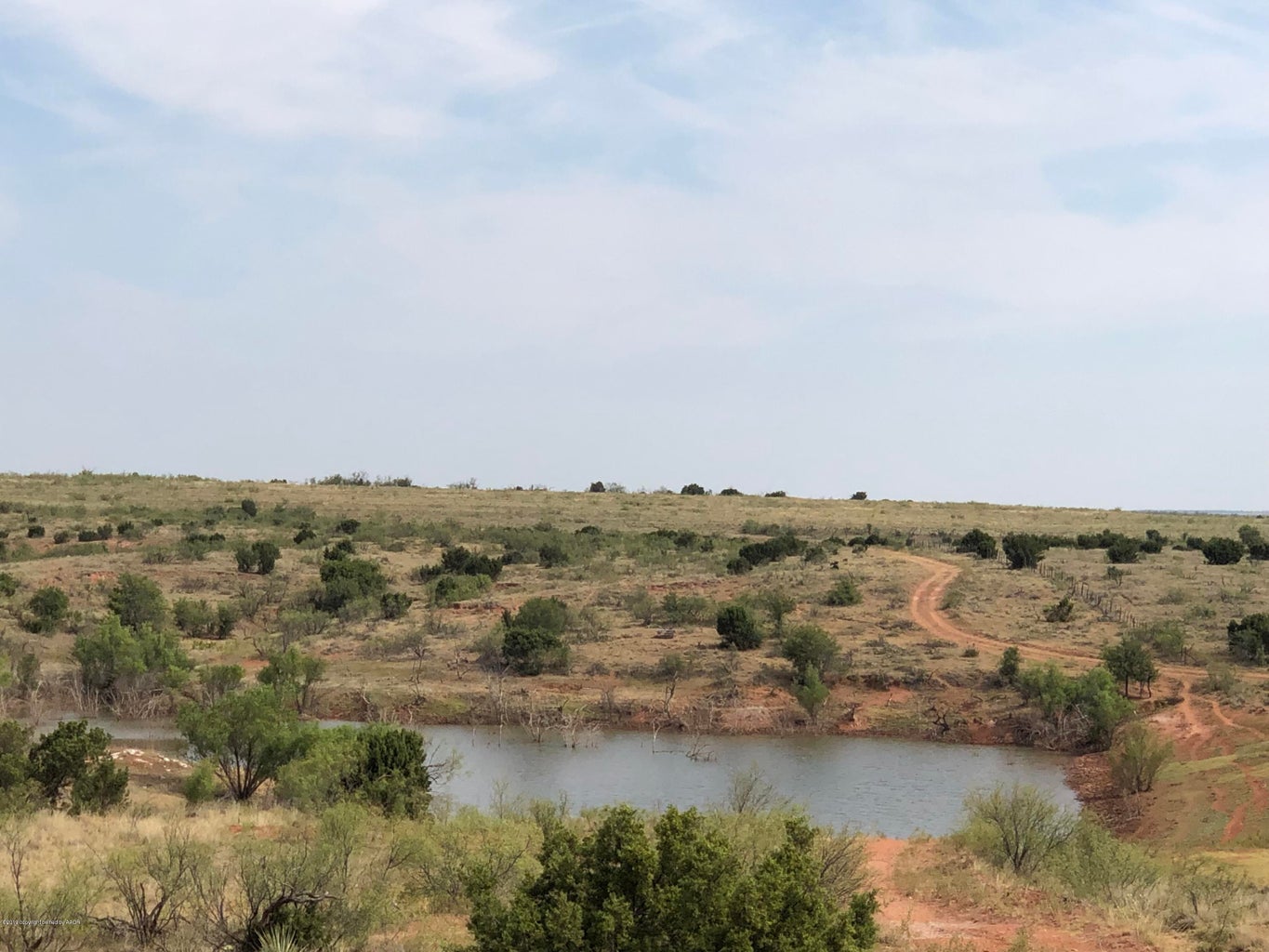 Located just 7 miles southeast of Turkey, Texas between Mockingbird Draw / Wind River and Wolf Flat, this 515.46 acres, more or less, consists of prime hunting and grazing with wet weather creeks, small pond, two smaller stock tanks, carports, barns, sheds and livestock pens. Approximately 200.61 acres is in improved grasses with the remaining 314.85 acres in native pasture with moderate to deep draws, canyons, bluffs, mesquite, cedar, hackberry, lotebush and some scattered tree groves and brush. This all provide good grazing, water and shade for cattle as well as excellent habitat, cover and bedding areas for wildlife. Wildlife includes white tail deer, mule deer, turkey, dove, quail, wild hogs, and varmints. There is approximately 100 acres on south side of County Road BB (some Google Maps call it AA), between County Road 7 and County Road 8, that is separated from the remining 415 acres, and is all improved grasses that could be used in a rotation program, or for horses, bulls, etc. As is, this property would make a nice place to live, run cattle and horses, with the bonus of excellent hunting. If so desired, it would make an excellent location to build a new home, barn dominium, or additional hunting cabin upon.
LEGAL DESCRIPTION: 515.46 acres, more or less;
173.26 acres, more or less, in Section 197, Block S-5, D & P Ry. Co. Survey, Hall County, Texas.
145.50 acres, more or less, in Section 195, Block S-5, D & P Ry. Co. Survey, Hall County, Texas.
196.70 acres, more or less, in Section 38, Block S-5, EL & RR Ry. Co. Survey, Hall County, Texas.
MINERALS & MINERAL RIGHTS: 25% of any minerals owned are to convey. There is no production on or near the property.
IMPROVEMENTS: Cattle Pens. A 900 square foot metal shop, several carports and other outbuildings. Automatic gate allows easy access.
FENCES: Good to excellent five strand barbwire perimeter fence.
TOPOGRAHY: With 75'+ of elevation changes there are several ideal locations for hunting blinds, food plots and game feeders along the cliffs and more level areas of the old cultivated fields.
FSA BASE ACREAGE: The entire property is in improved and native grasses. Previous FSA Base Acre and Yield information available upon request.
WATER: Water well supplies water to the house
UTILITIES: Lighthouse Electric rural electric line. Caprock Telephone supply internet and telephone service to the house.
SURFACE WATER: One small pond that has had the spillway recently fully repaired. There are two other small stock tanks that catch water from wet weather creeks.
WATER RIGHTS: All water rights will convey to buyer.
WIND RIGHTS: All wind rights will convey to buyer.
ZONING: Agricultural. Located outside of any municipality.
SEPTIC SYSTEM: In place.
TAXING DISTRICT: Taxes for 2018 were approximately $
EASEMENTS & RIGHTS-OF-WAY: Any easements or rights-of-way are not expected to affect the operations of this farm. Commitment for Title Insurance will identify all existing easements and rights-of-way.
POSSESSION: Upon closing and funding.
HUNTING LEASE: None in place.
GRAZING LEASE: None in place.
PERSONAL PROPERTY: No personal property to convey. (Please note that the 2,040 square foot Patriot Manufactured Home facing the south, built in 2006 with a large master suite on east end and three other bedrooms and a bathroom on the west end, large front covered porch and water softener system was Personal Property with a Title and HAS ALREADY SOLD, CLOSED AND FUNDED SEPARATELY on July 1, 2020).