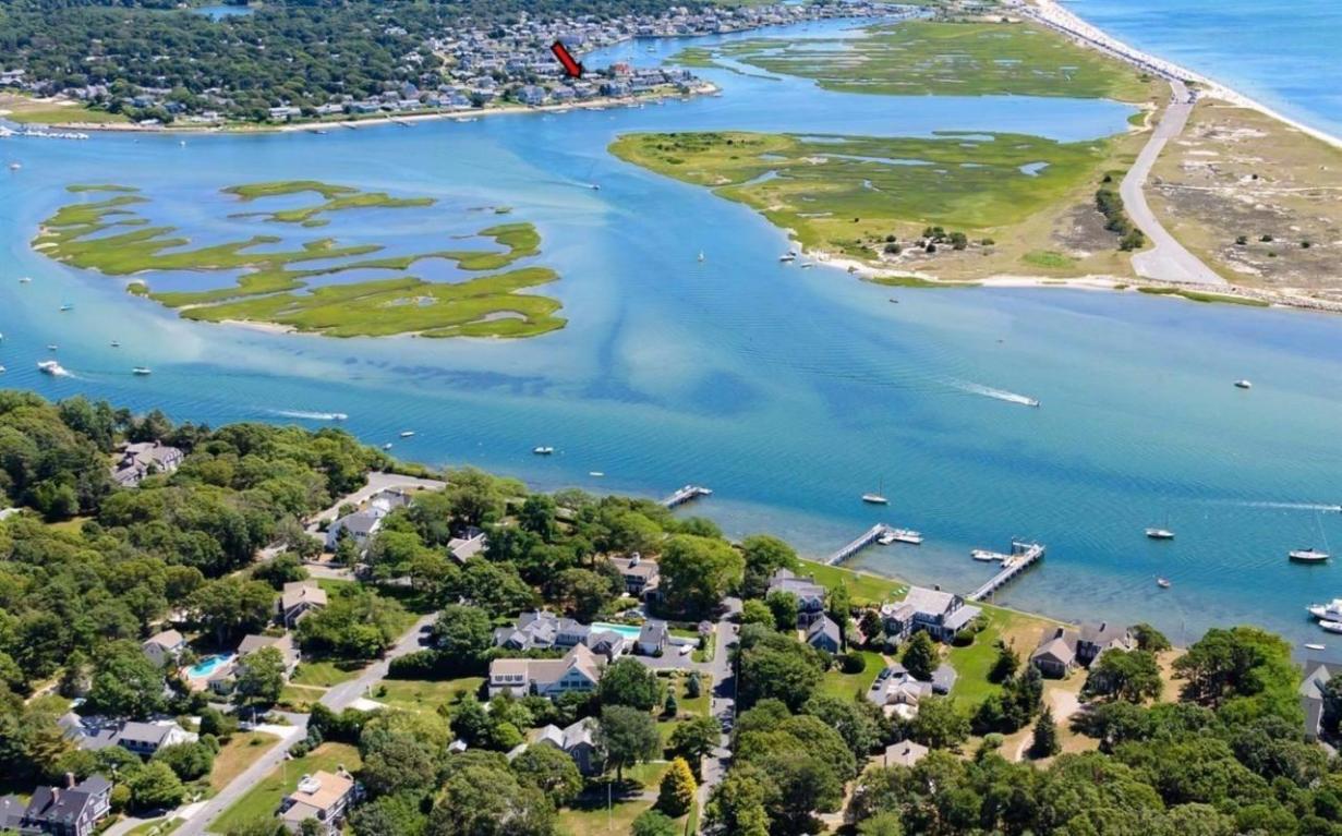 Boater's Waterfront Paradise in West Dennis - Exceptional location offers seaside living with a private sandy beach and DEEP water dock ready for multiple boats! Incredible sunset views of the Bass River and Nantucket Sound. Large cape with lots of glass opens to seaside deck and DEEP water dock. Minutes from beautiful West Dennis Beach. Large open kitchen-dining-family area, 5BR's, 3.5 baths, fireplaced LR, 2nd floor waterside deck, and more!
