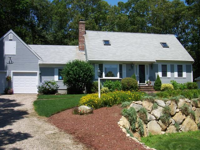 Sunfilled Cape with skylites and large open living area, fully applianced, eat-in kitchen with sliders to private back yard deck, den with fireplace, 4 large bedrooms, 2 car attached garage and stroll to private association tennis and beach.