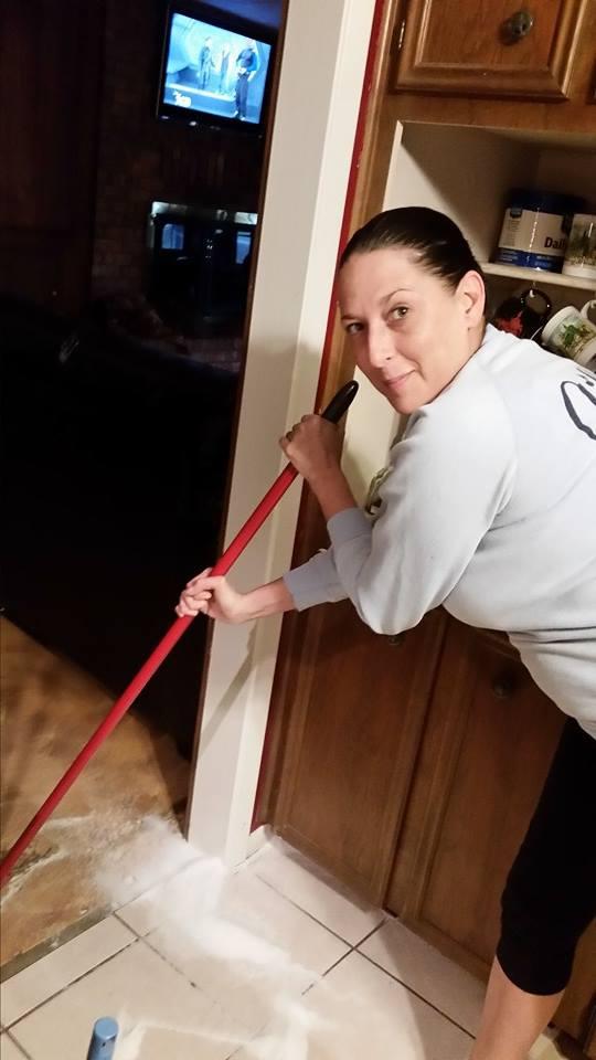 Vanessa cleaning up her mess, she spilled 5lbs of sugar.