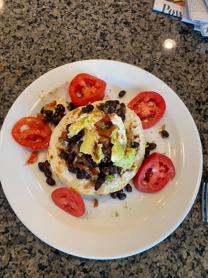 Poached eggs, black bean hash over a tortilla
Jalapenos, cumin, onion, shallots , garlic,hrrbs, avacado ,lime , with a tomato garnish