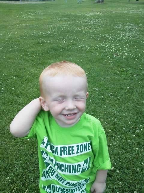 My little red-headed grandson Logan, showing off his new haircut.   He keeps his brothers and sisters on their toes!