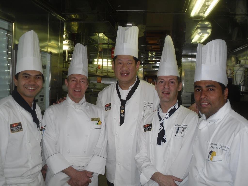 Cunard . Waiter on the Queen Elizabeth, cook on the Queen Victoria and for my finale will be to wear the captains cap on the bridge of the Queen Mary 2.