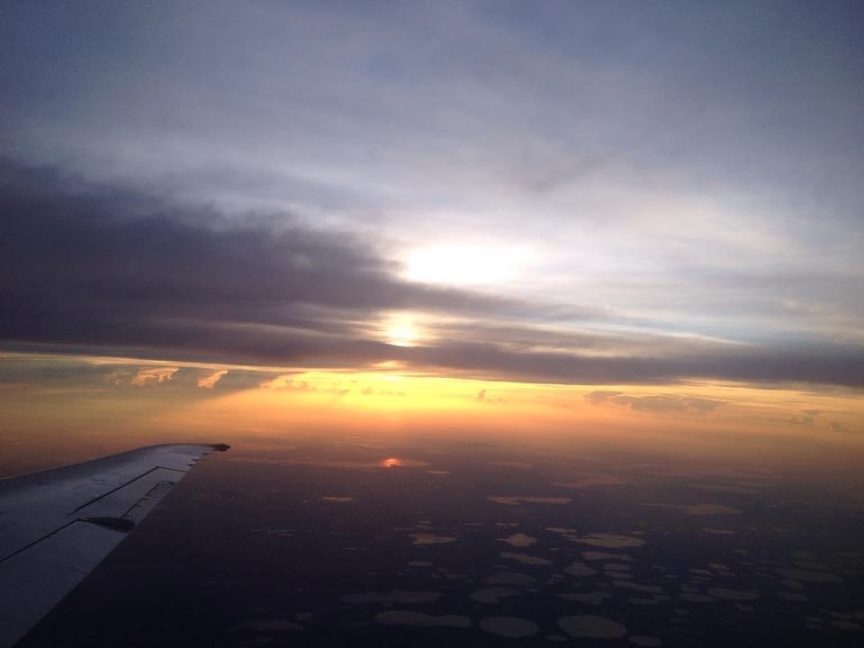 Picture of sunrise outside my airplane window this morning. You can see the airplane wing to the left.