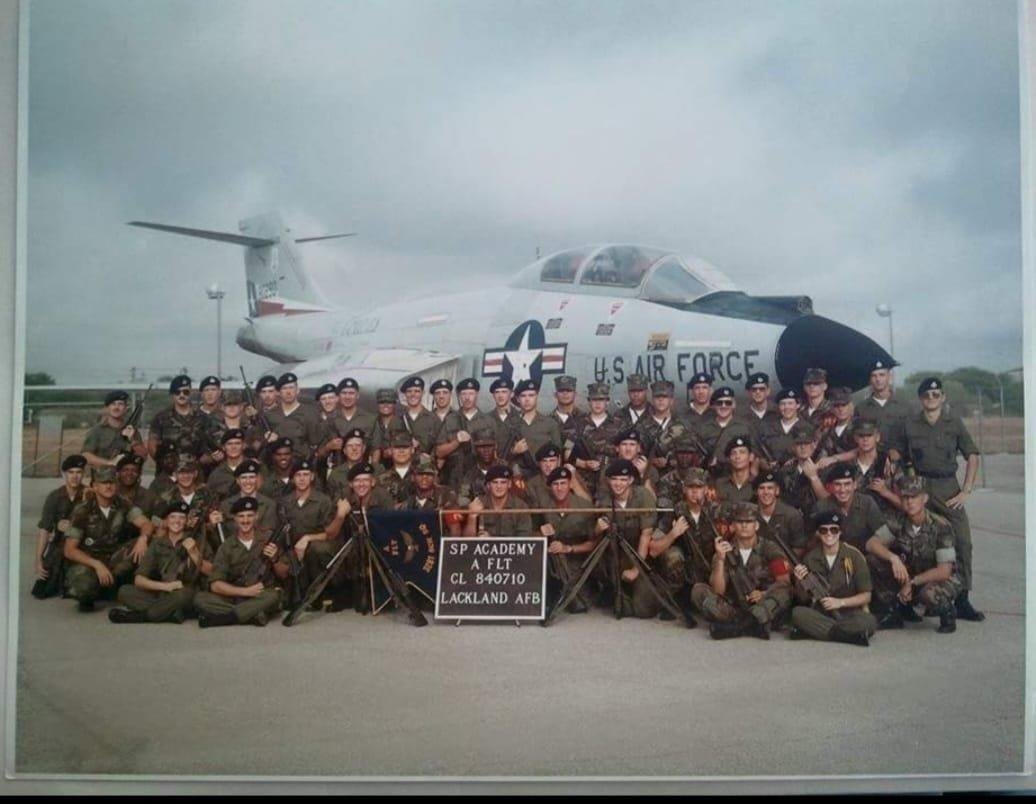 Class photo of my Security Police Tech School Class, taken in late June, 1984. I'm on the right, under the R in FORCE, with sunglasses.
