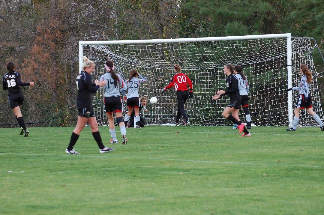 Daughter slides the ball into the net