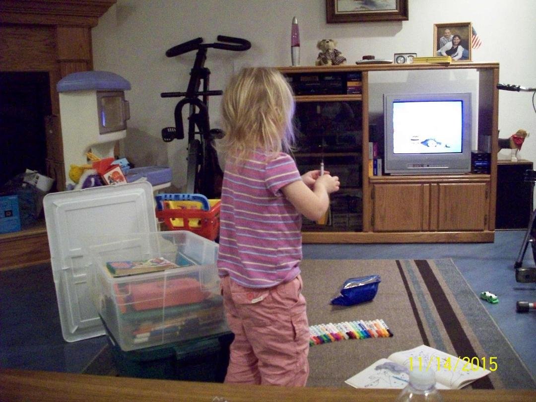 Putting crayons back in the box.