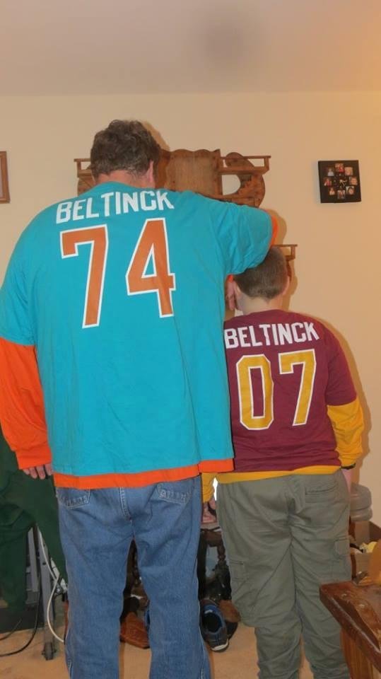 Jay with youngest Grandchild wearing their Christmas gifts.