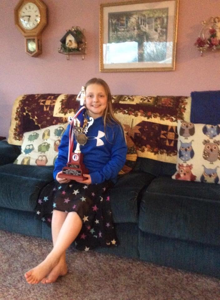 Anna stopped to show off her trophy. Second place in regional free throw at Iowa City.