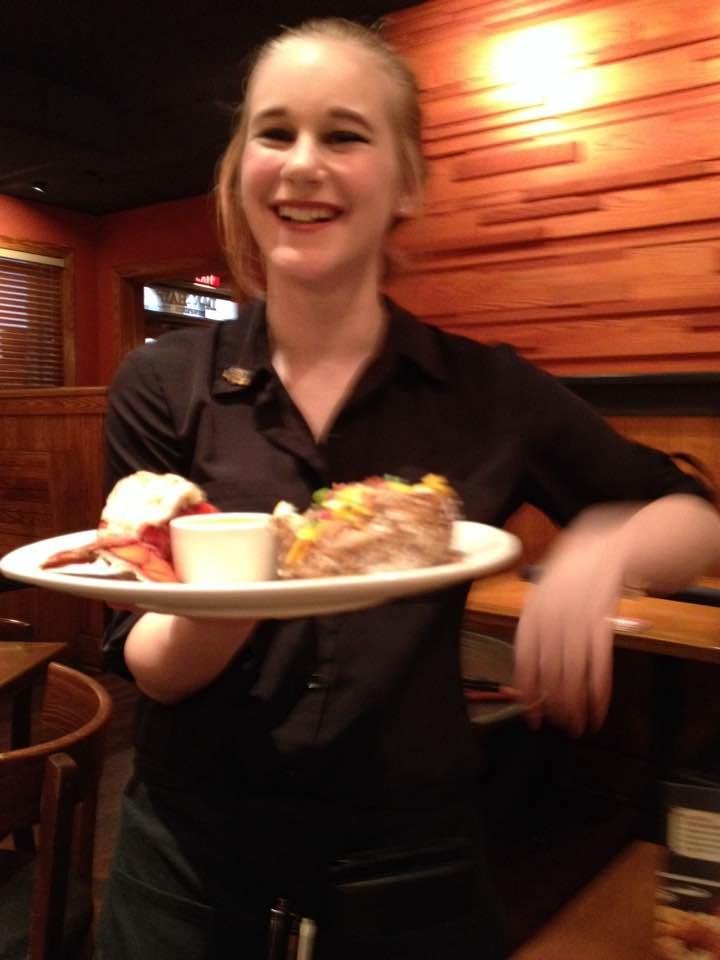 Kaly serving my lobster and steak at Outback. I love gift cards!
