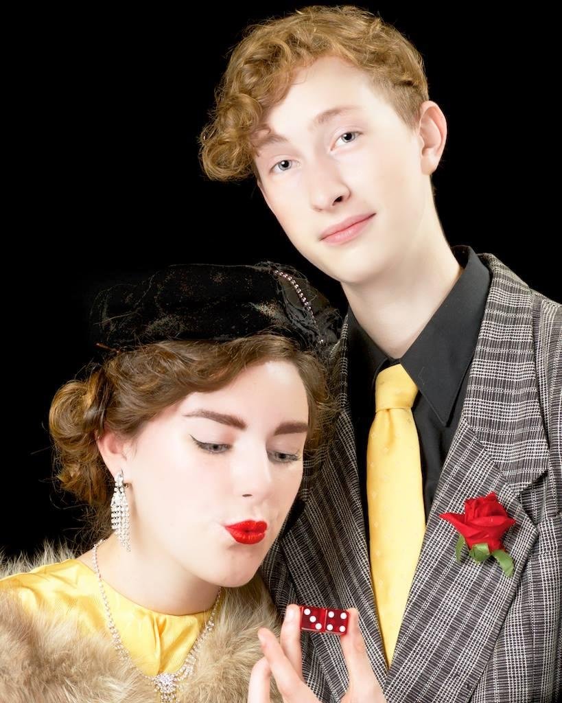 Crap game promoter Nathan Detroit, played by Ryan Doyle, is preparing to shoot as his fiancee, Miss Adelaide, played by Emma Harris, blows on his dice for luck and hopes he will finally marry her after their 14 year engagem