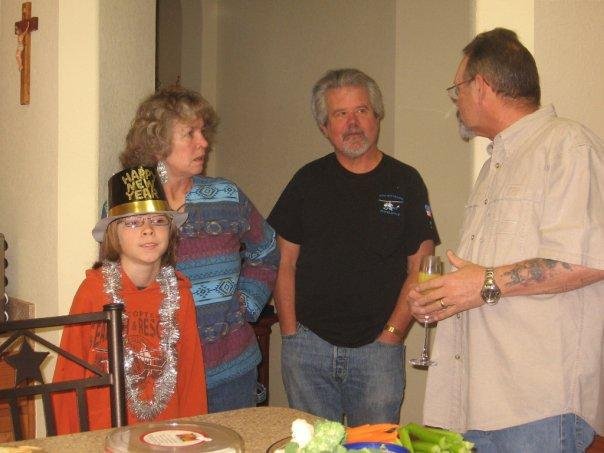 Sandy and Len chitchatting with Lee. Marshall in his New Years party gear.