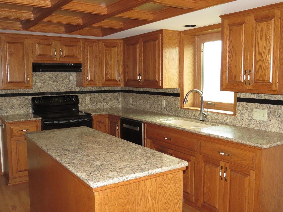 While the dishwasher looks black in this photo, it's actually stainless steel, not black-- it's just the angle and lighting that make it look black.