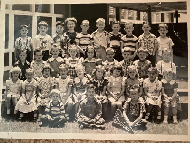 This is Kindergarten (unless I'm wrong, and it's first grade). I think K. This, then, would have been taken in the spring . . . 70 years ago? I'm the tallest one with the goofy hair . . many cowlicks . . . and that stupid s