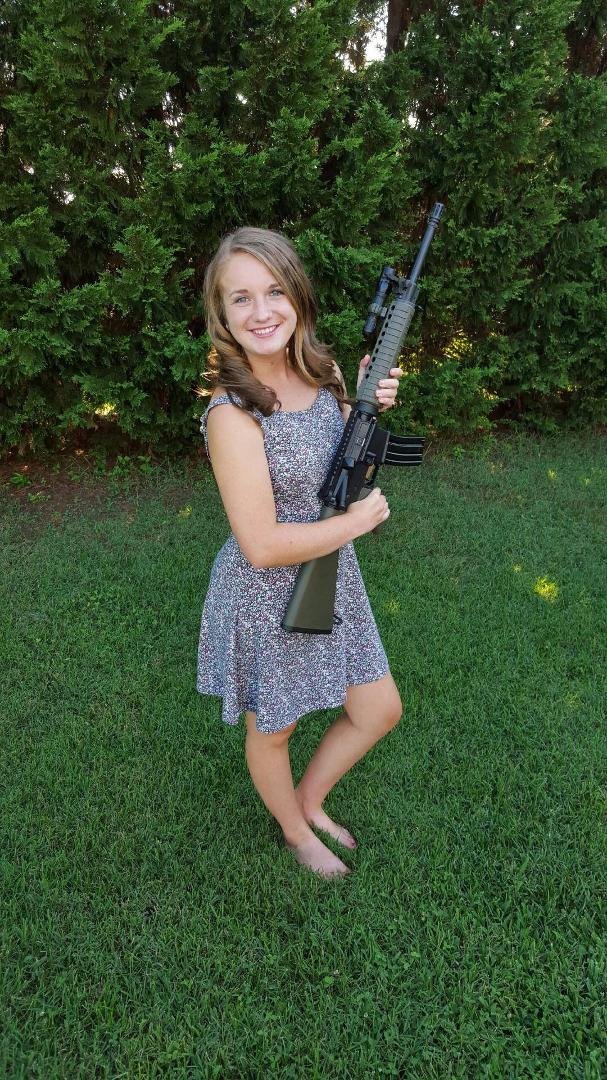 My granddaughter Ashton Eades holding my latest purchase AR-15. They are cute!!!!