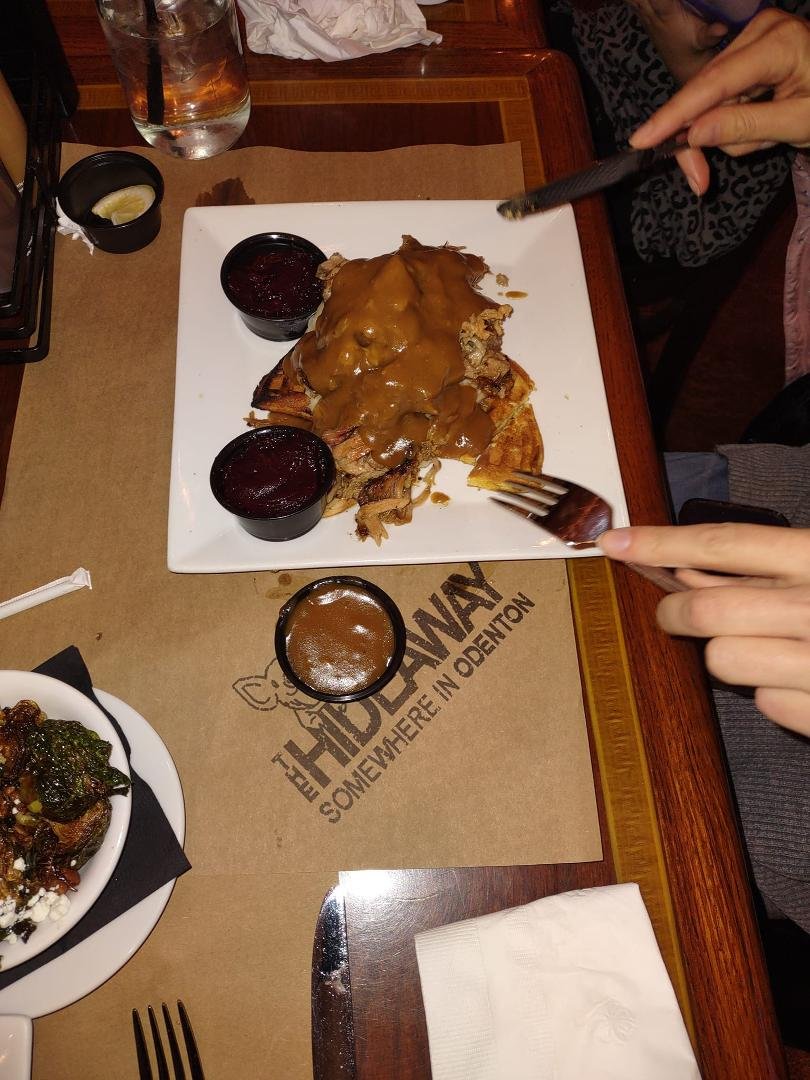 The Waffled Pig, a corn bread waffle topped with pulled pork BBQ, mashed potatoes & gravy
