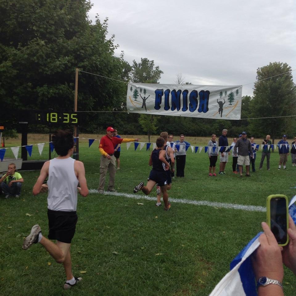 Grant as he crosses the finish line at the Rambling Rock Cross Country Invitational meet at Willow Metropark today. This was his best time and his first time running as a varsity member and he is only a freshman.