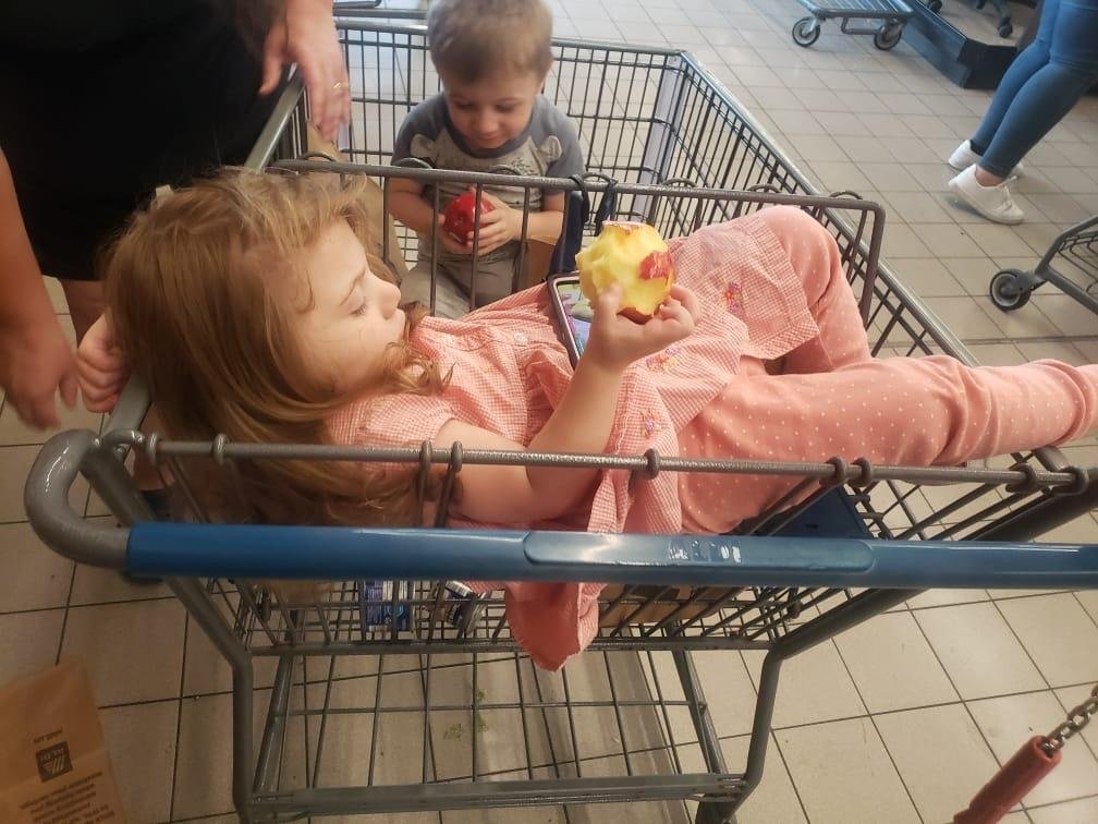 Wrynn relaxing, eating an apple while watching Cocomelon while we were all shopping at Aldis..lol