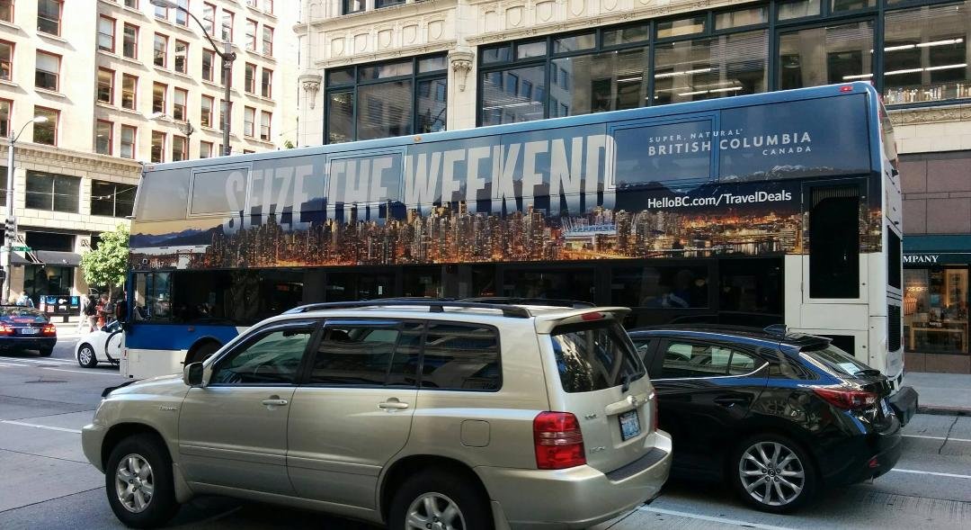 Bus in downtown Seattle featuring ads for BC.