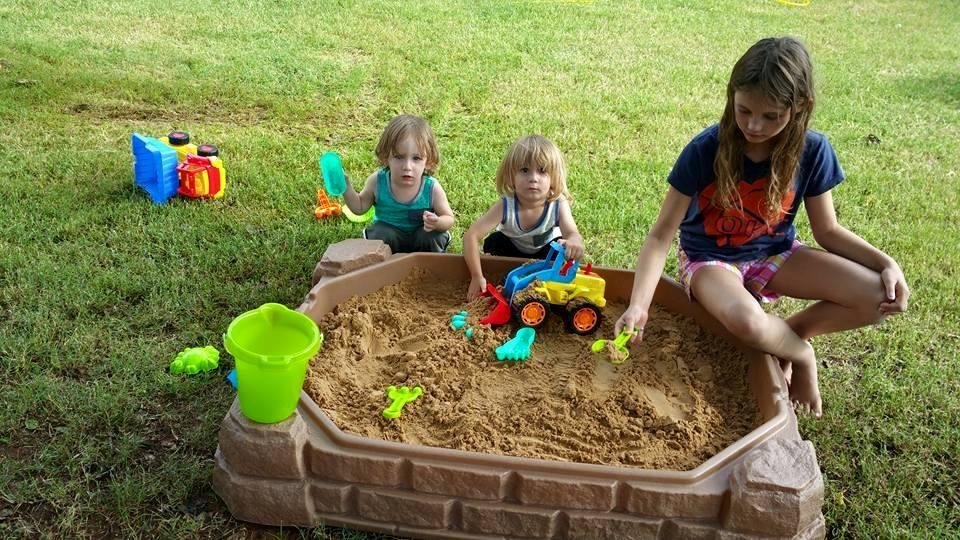 Nolan and Beckett moving sand by the ton with big sister Madison standing by to assist.