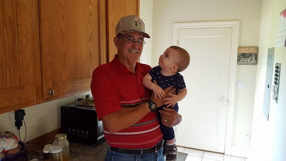 Quinn trying to figure out how to grab Gpa Genes hat.