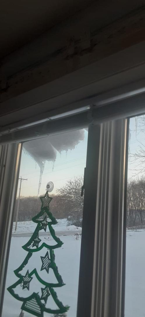 Snow and ice about to slide off roof of sun room.