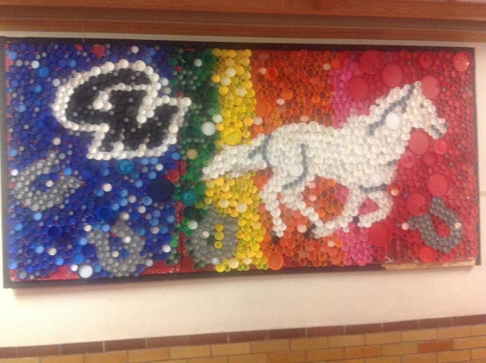 This piece of art is in our daughters' school hallway. It's made out of different types of bottle caps!! Isn't that neat!