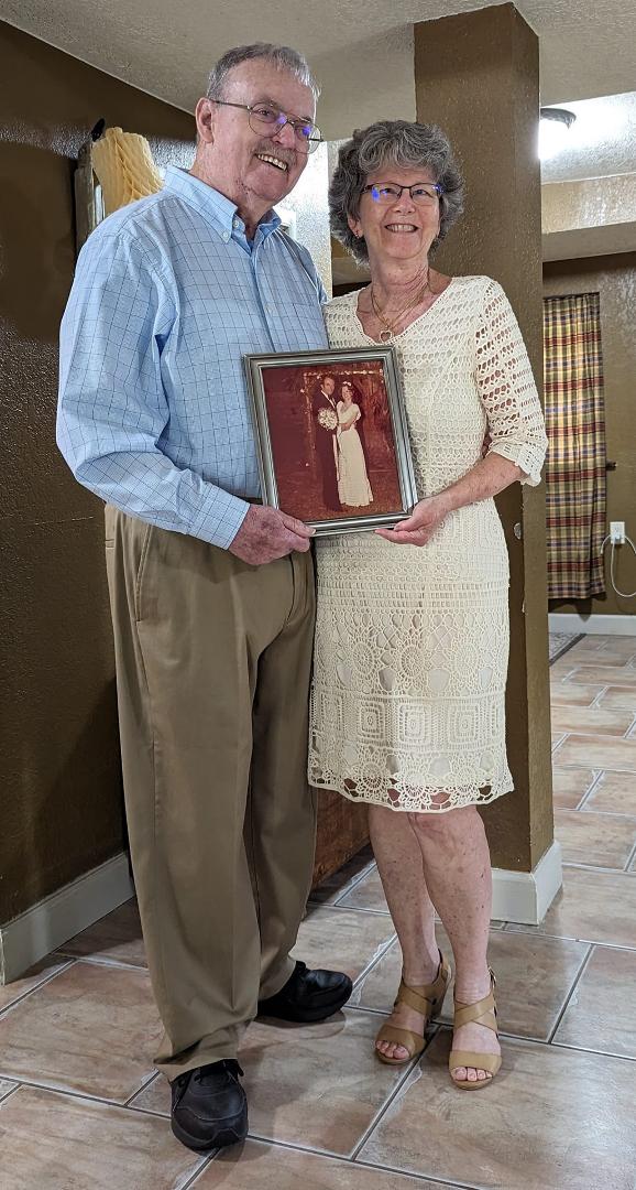 Holding our Wedding picture from 46 years ago.