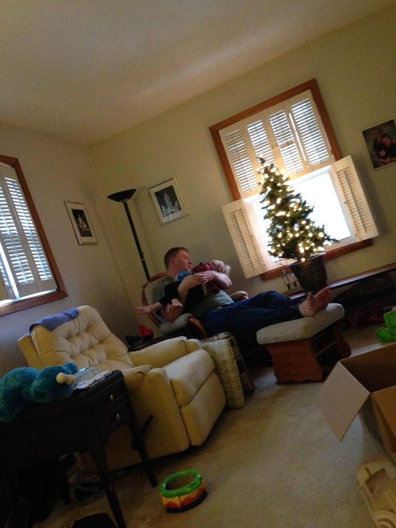 Andy, the baby whisperer, at work 10 minutes after he walks in my house Christmas Day.