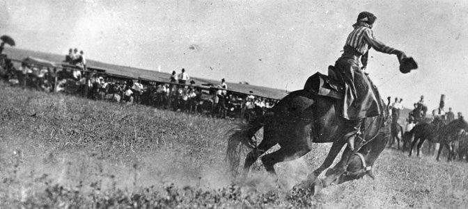 Female bronc rider. Notice there is no fence.