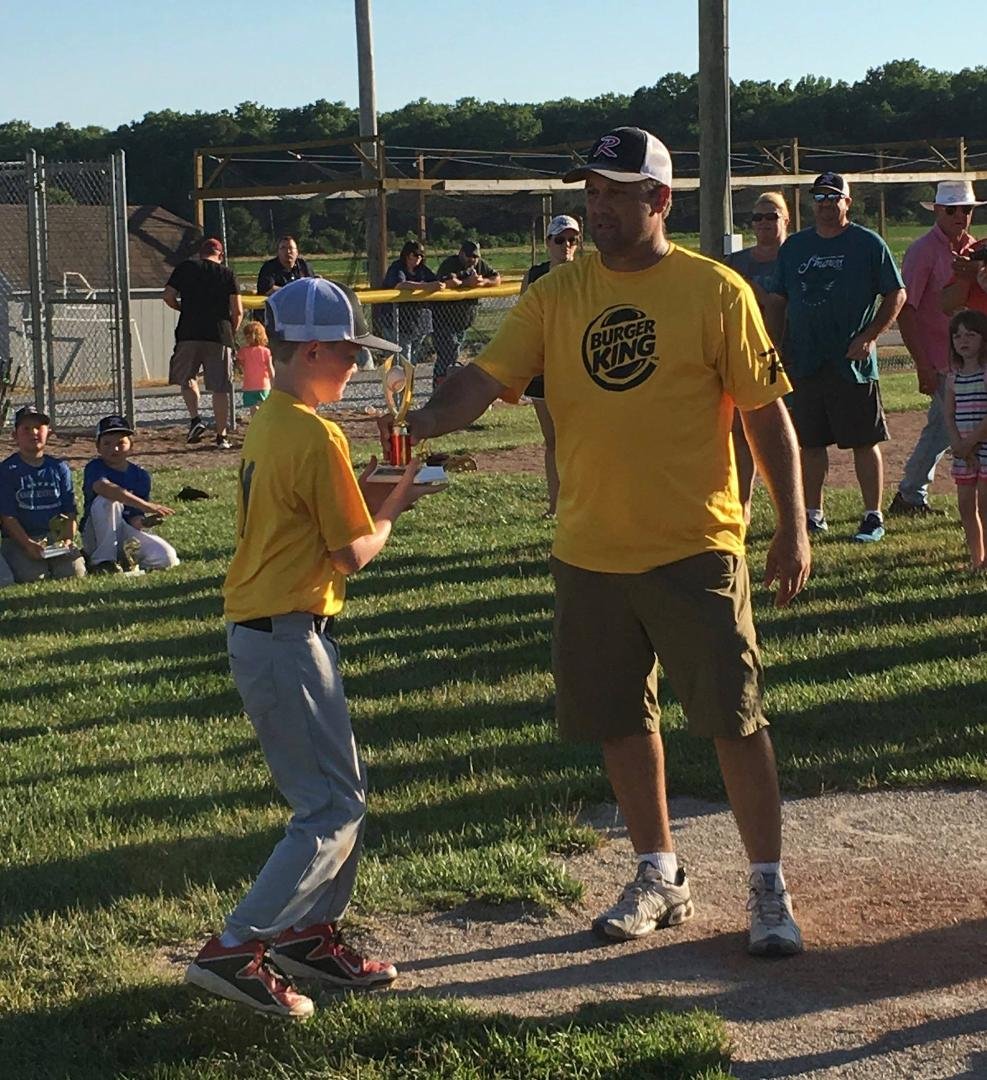 Dane getting his trophy from Coach Vernon for winning the Championship Game...