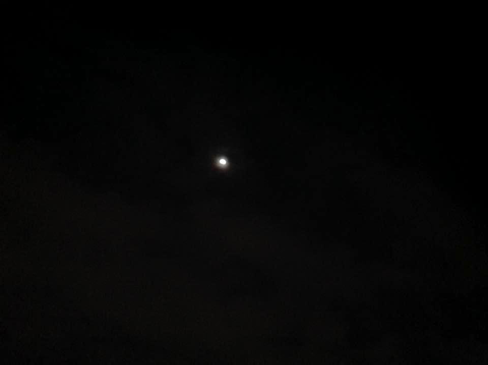 Lunar eclipse before hiding behind clouds.