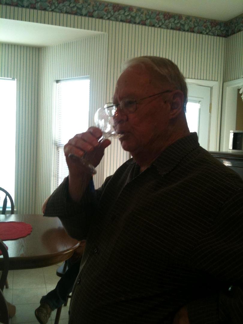 Papa enjoys his first taste of champagne. Or did he?