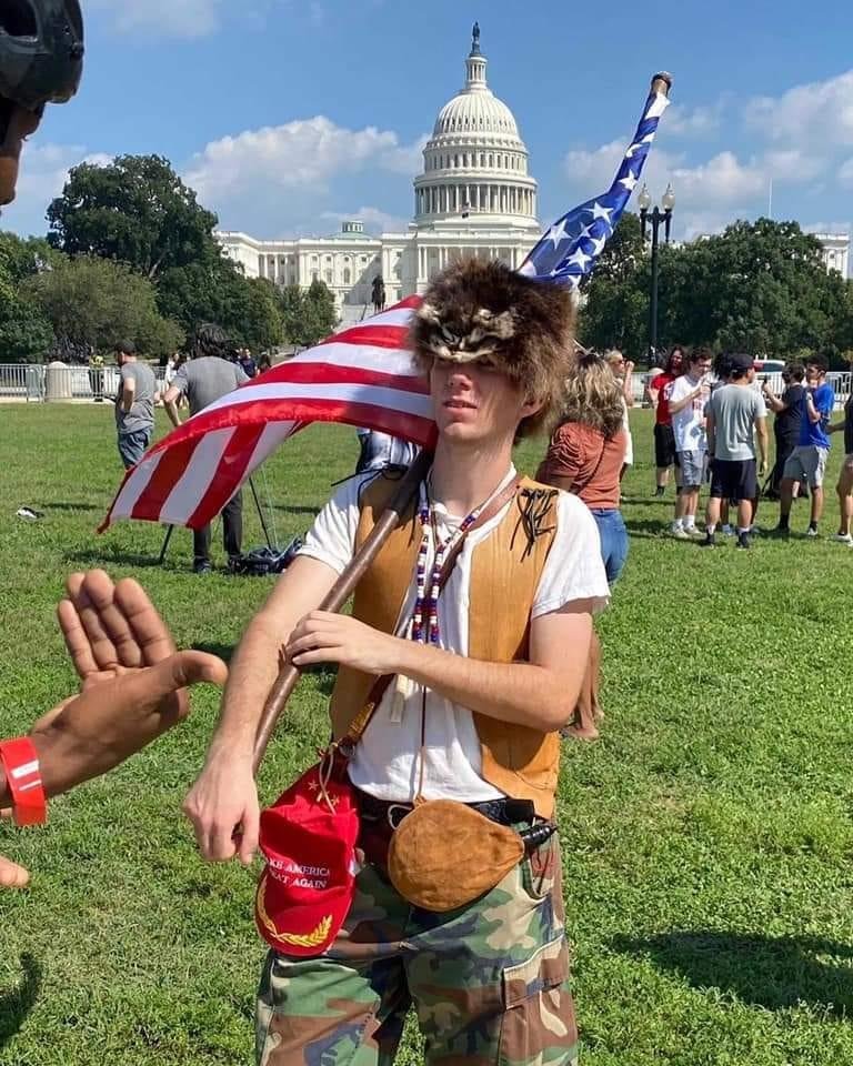 In the wilds of DC, we have here a baby QAnon shaman. Approach it calmly, don’t make any sudden moves or you’ll scare it off. Hopefully, we can return it to its natural habitat—it’s mother’s basement.