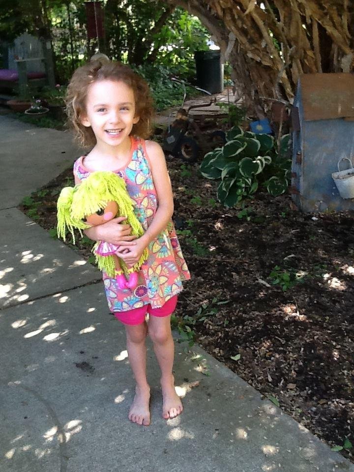 Five year one day old, playing with her new doll from Grandma Gail Danielson and Papa.
