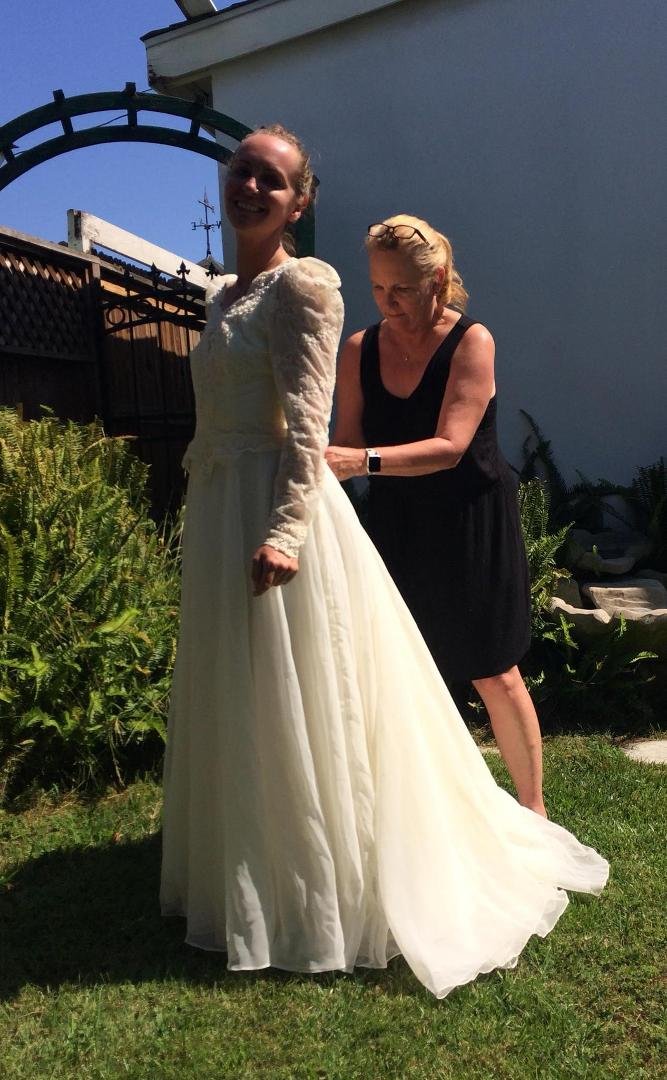 Amanda putting on her mother’s wedding dress