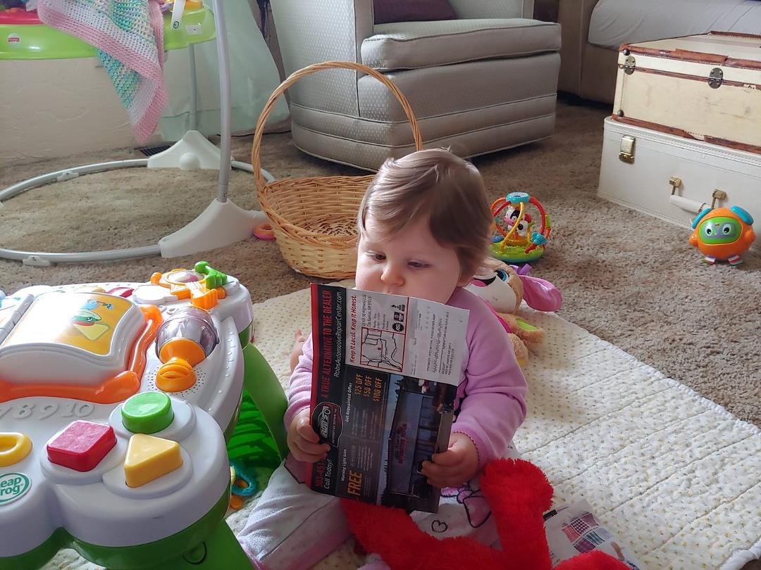 Charlotte "reading" junk mail.