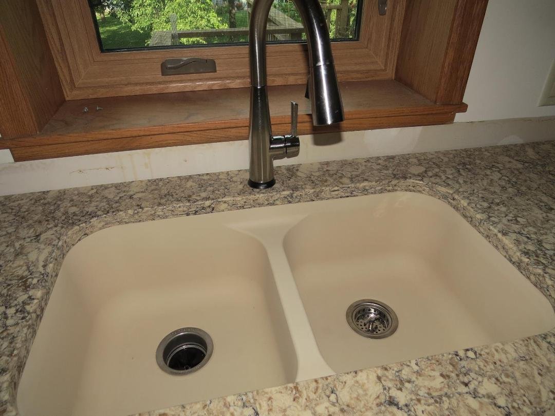 New quartz composite sink to replace the old stainless steel one and new brushed chrome faucet. At the point that this picture was taken, we hadn't yet gotten our new backsplash.