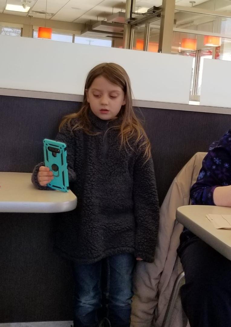 Luke, looking for ghosts at Wendy's with phone app "Ghost Detector".