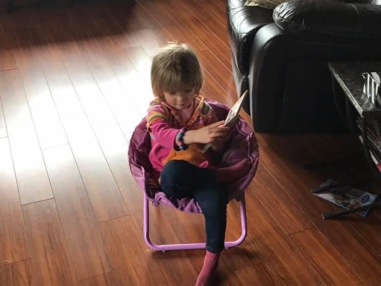 Olivia reading us a very exciting book ( notice the crossed legs ) lots of fun today