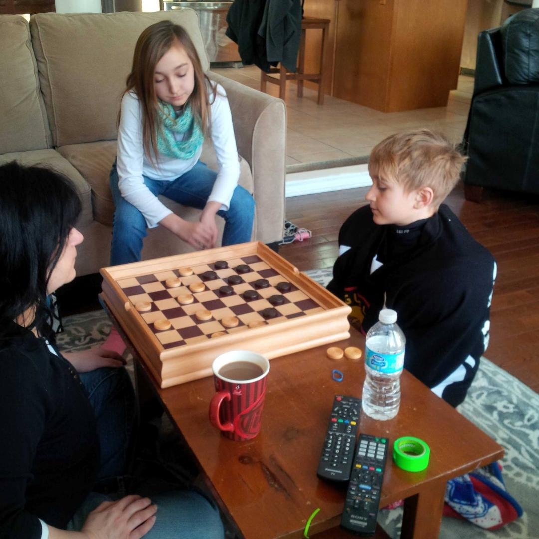 Big sunday checker match! See Ethan needs his hockey gear on, you never know what Mom will do if she loses.