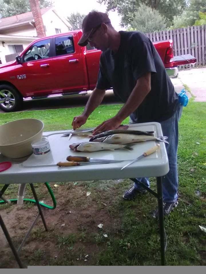 nick cleaning todays catch. we got 14 out of 18 we could have got. to many storms around couldnt stay where fish were. even had a water spout. my new truck.