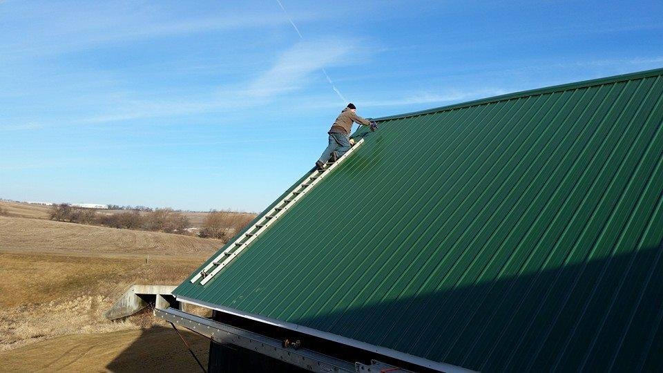 This is how you put the last piece of steel on a barn roof.