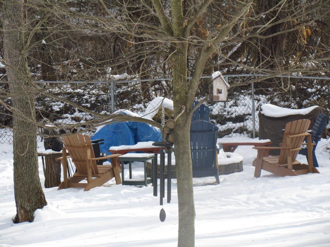 In addition to Elaina wanting us to see her new American Girl Doll, Chris wanted to help me put together the two new Adirondcak chairs that he gave me for Christmas. They are together and in place at the fire pit. They lo