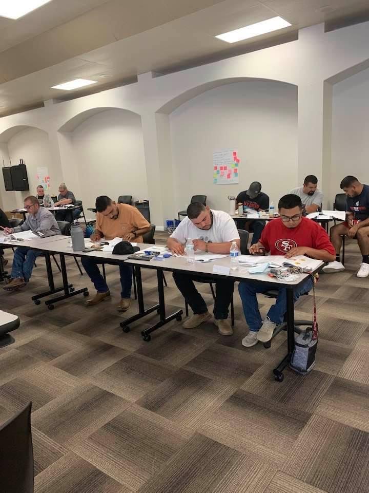 Basic custodial certification training being hosted by the Burton school district. We have 28 custodians participating in this two day class. In this picture, students are reading chapter 4 on hard floor care and answering