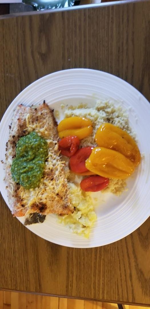 Panko-Parmesean crusted sockeye salmon with pesto sauce and couscous with roasted peppers in sesame seed oil.
