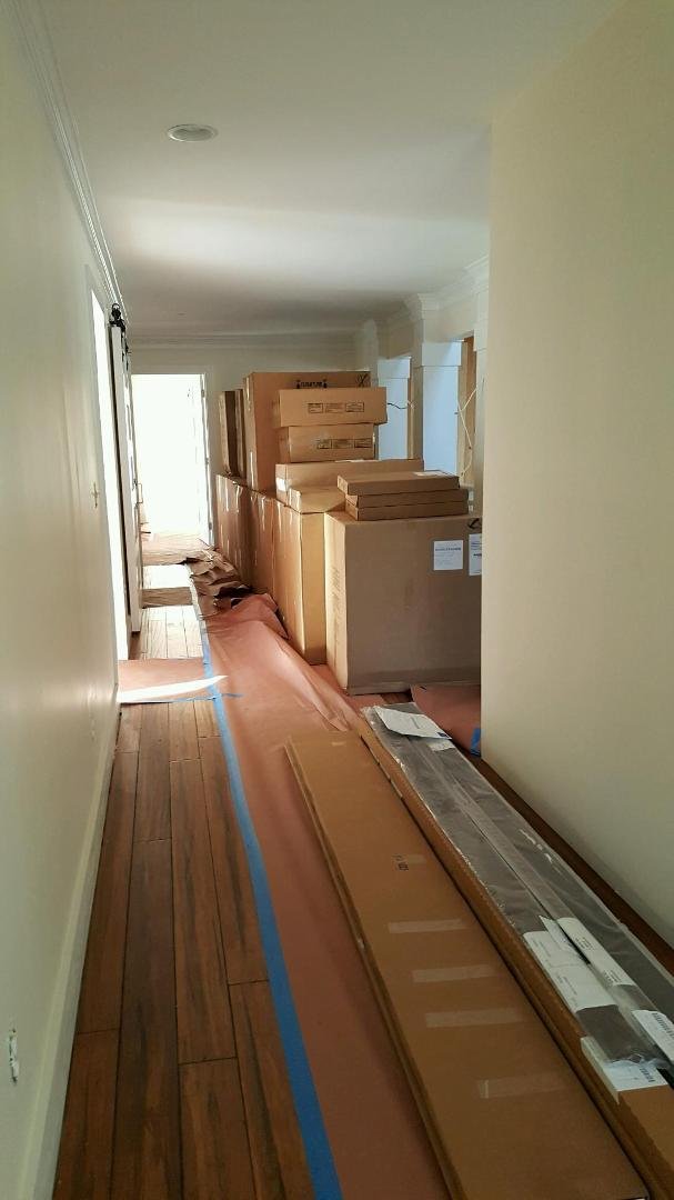 Kitchen cabinets have been received n delivered to the house. This is what got stacked in the hall.